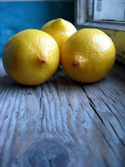 Yellow fresh lemons on an old retro window sill