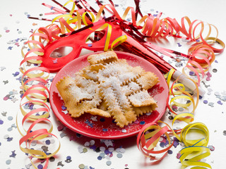 carnival fritters on red dish over steel table