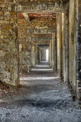 Tuinposter Long empty corridor and doors in abandoned building © tobago77