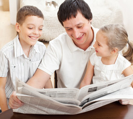 Family reading a newspaper