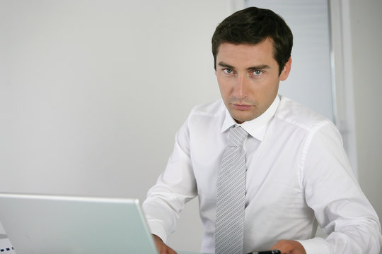 Stern Businessman Sat At His Desk