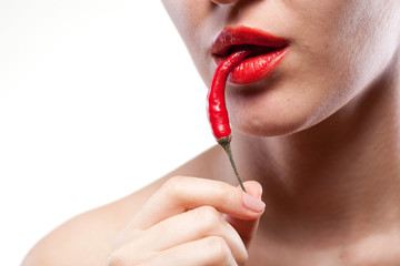 Young woman with chili pepper isolated on white