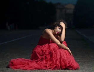 Beautiful woman in red dress at sunset