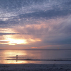 Fototapeta na wymiar young man and sunset on sea