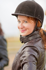 female jockey in protective helmet