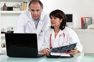 Fototapeta na wymiar male and female doctors with laptop