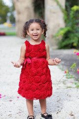 Happy child in a red dress