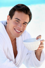 Man smiling with a bowl