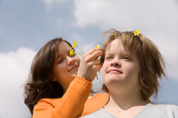 A girl with Down syndrome and her sister.