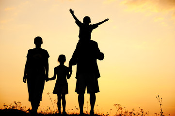 Children with mother and father, family at sunset