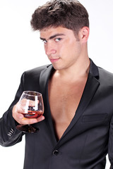 Man with glass of cognac on white background