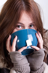 Girl drinking tea from a big cup