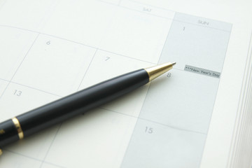 Happy New Year ,pen on book