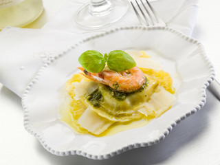 pesto ravioli with shrimp and parmesan flakes