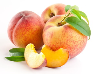 Ripe peach fruit with leaves and slises