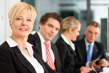 Business with female boss - team in office