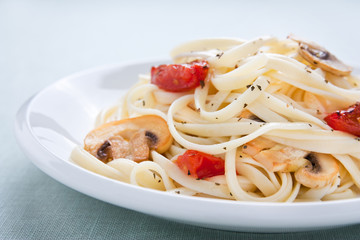 Tagliatelle sautéed with tomatoes and mushrooms