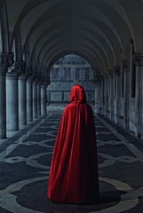 Woman in red cloak walking away - obrazy, fototapety, plakaty