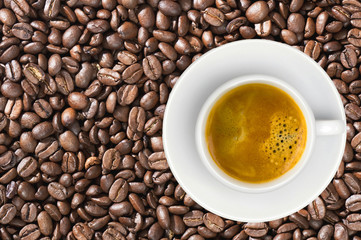 white cup of coffee espresso over coffee beans background