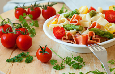 Delicious heart-shaped pasta with tomatoes and asparagus