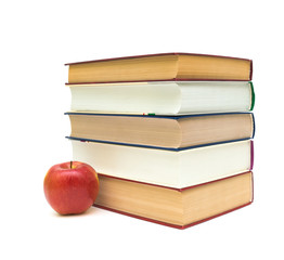 stack of books and a red apple on a white background
