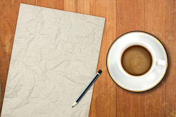 Obraz na płótnie Canvas paper and a white coffee cup on a wooden desk