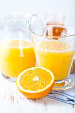 Glass and jug of fresh orange juice