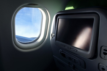 detail of airplane seat with tv screen