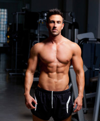 fitness shaped muscle man posing on gym