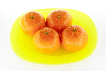 Tangerines on yellow plate