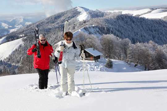 Senior Couple Walking In Snow