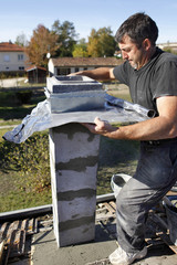 Builder using zinc flashing in the construction of a pillar