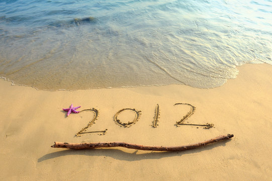 2012 happy new year written in the sand