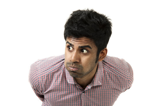 giovane uomo indiano, ritratto con smorfia, fondo bianco