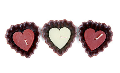 three candles in the shape of a heart