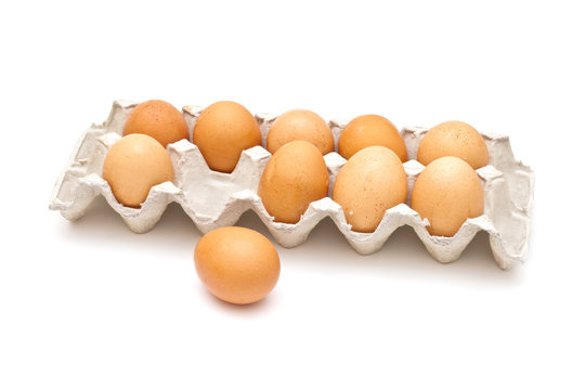 Brown eggs in a carton package on white background