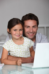 Father and daughter on laptop