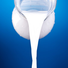 closeup of a jug with pouring milk