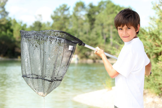 Young Boy With A Large Fishing Net