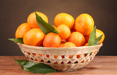 tangerines with leaves in a beautiful basket