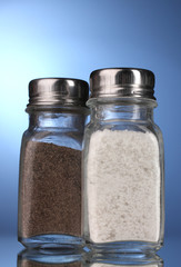Salt and pepper mills on blue