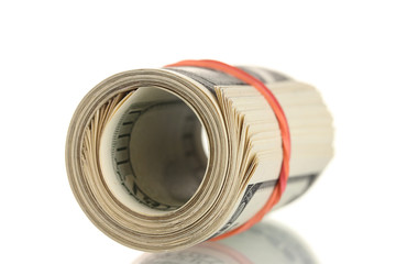 A lot of one hundred dollar bills tied rubber band isolated