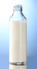 bottle of milk on blue background
