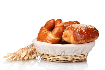 Baked bread in basket isolated on white