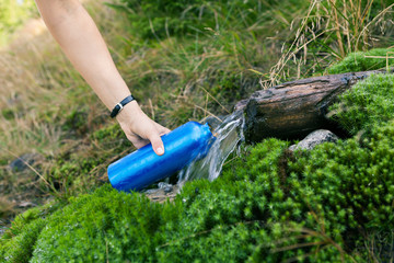 Woman taking water from spring