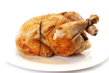 Whole fried Chicken on a white plate