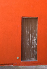 Old door in Italy on a red wall