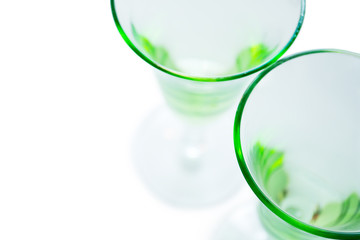 Transparent green glasses on white background