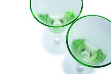 Transparent green glasses on white background