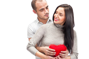 Happy young adult couple with red heart on white background, emb